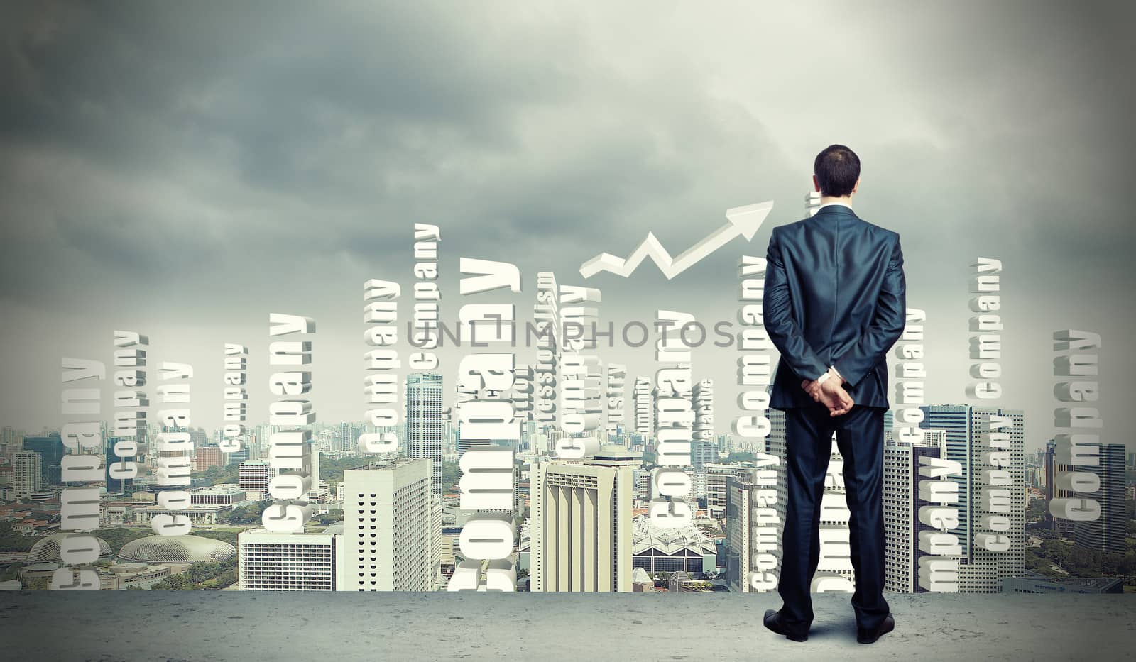 Successful young businessman standing against modern cityscape