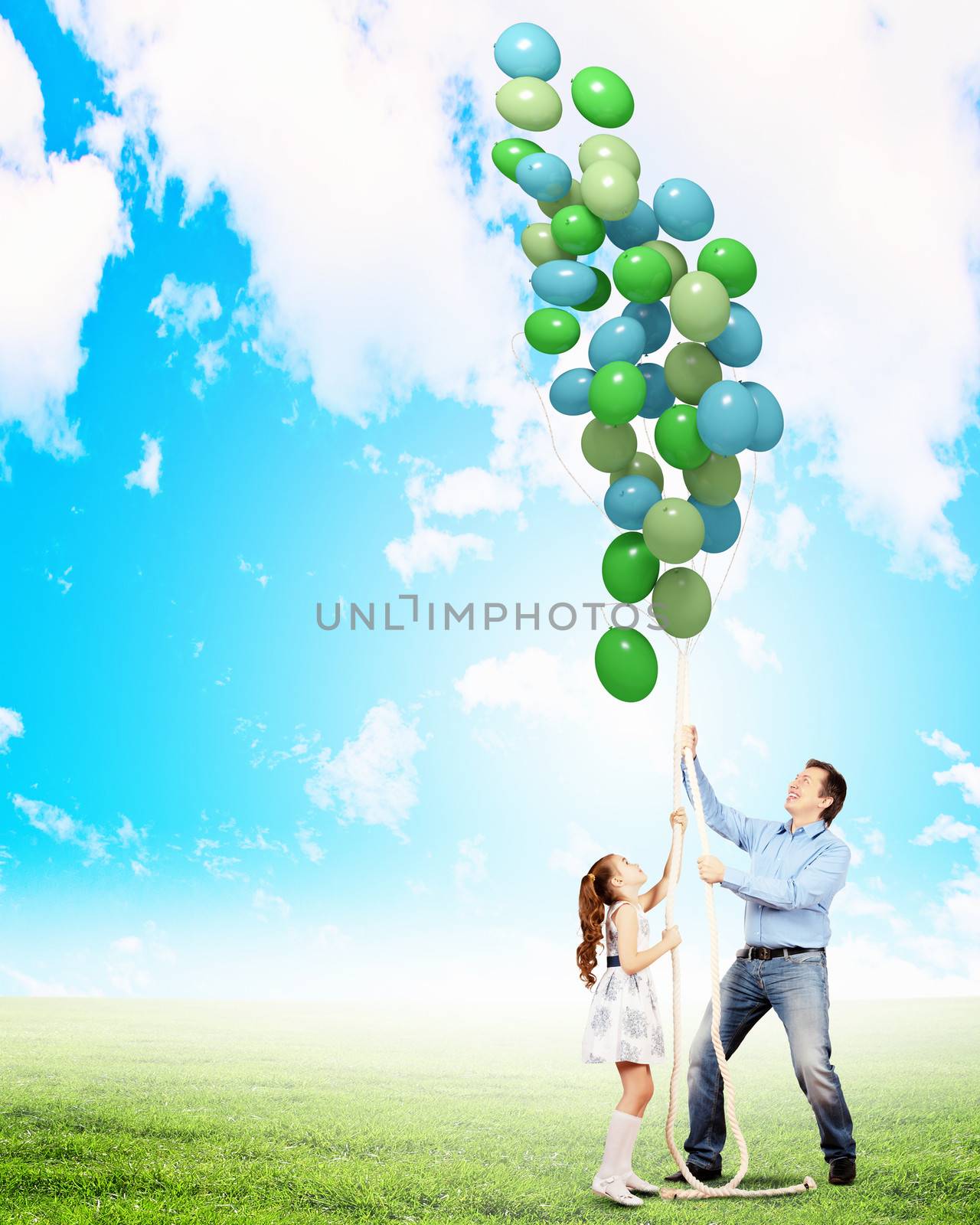 Image of father and daughter playing with bunch of colorful balloons