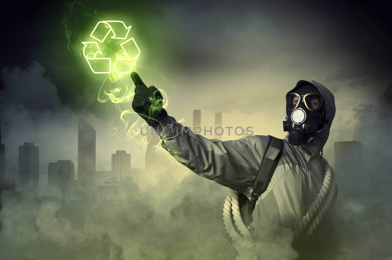 Man in respirator against nuclear background touching symbol. Recycle concept