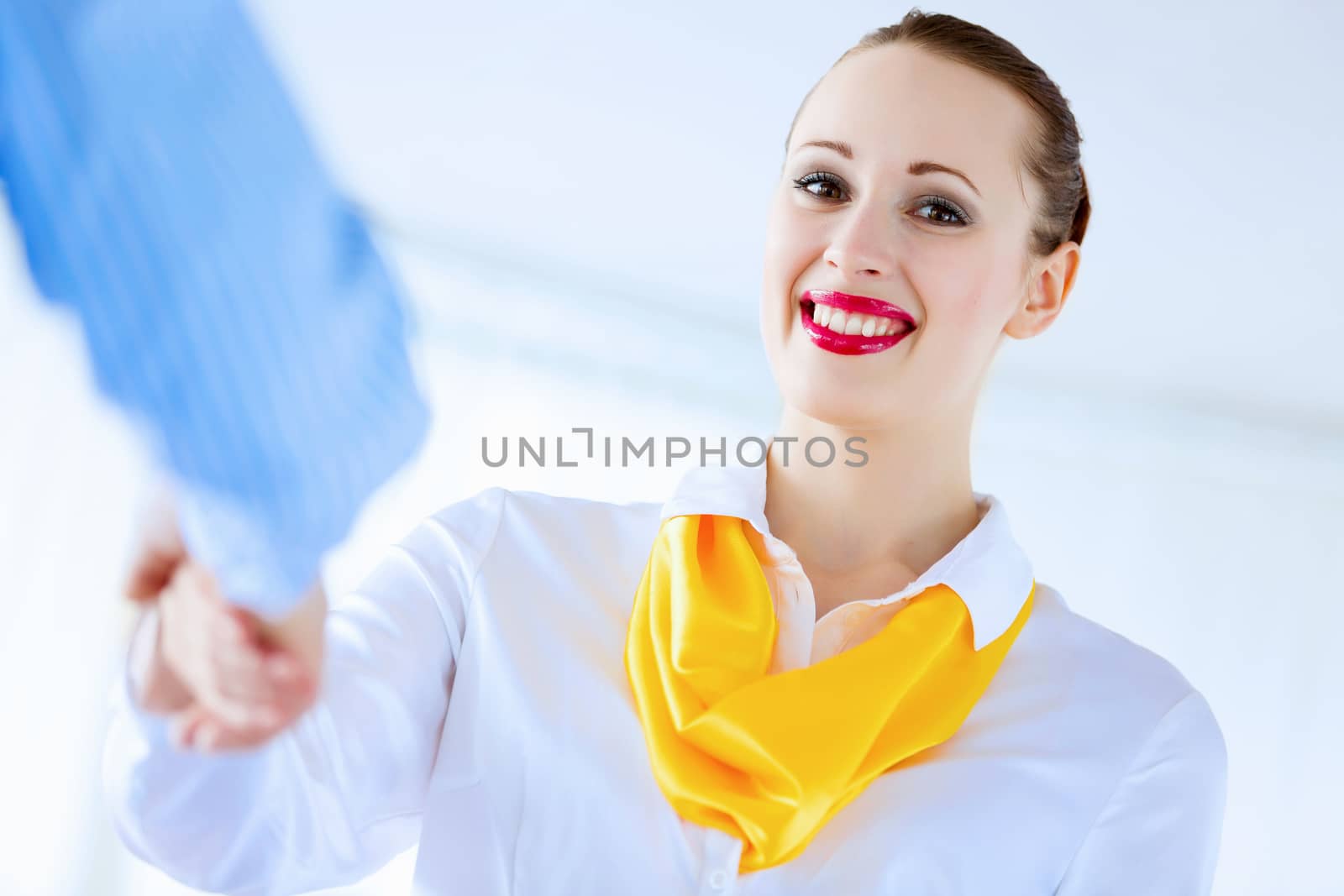 Image of successful young happy businesswoman shaking hand