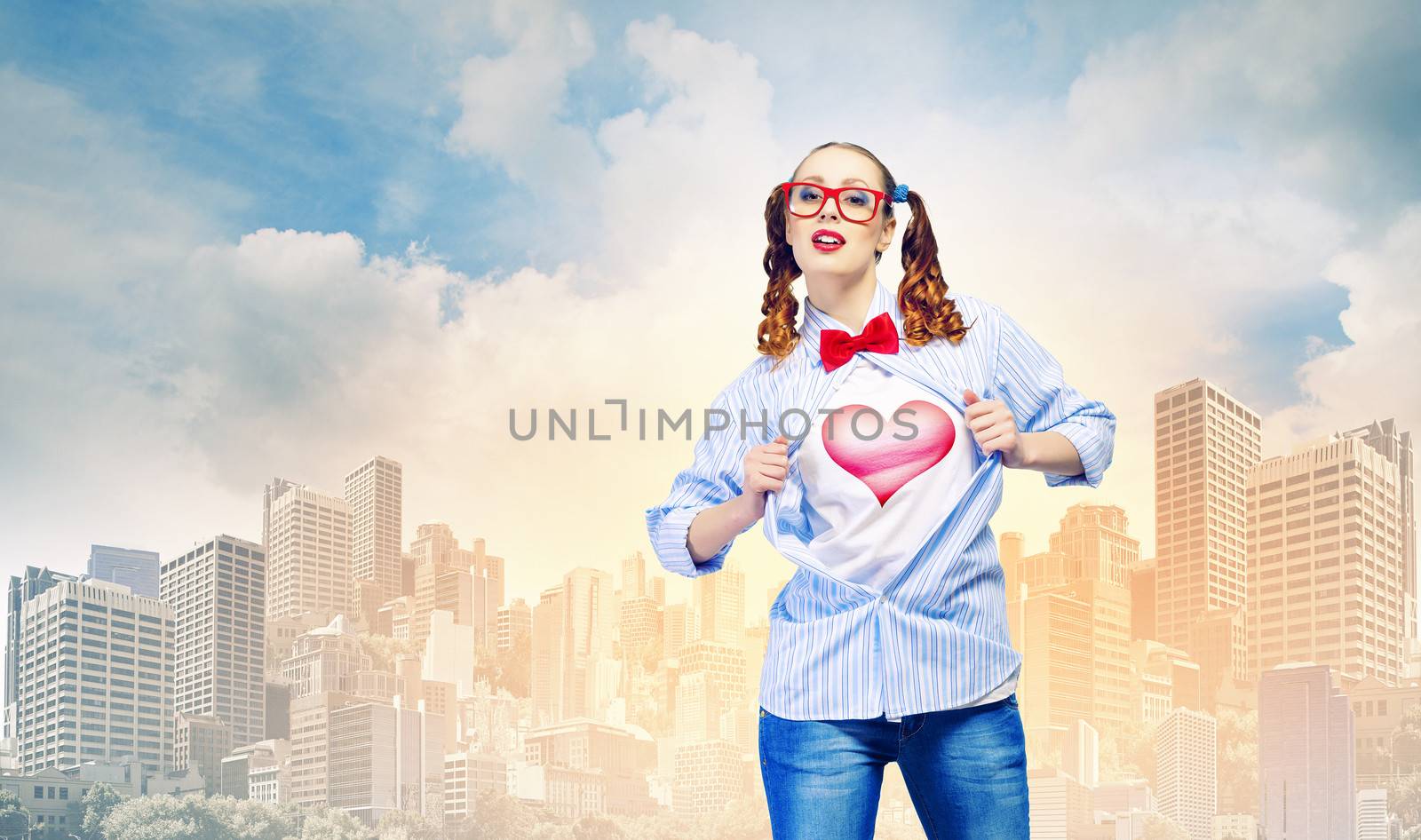 Young woman acting like super hero with heart sign on chest