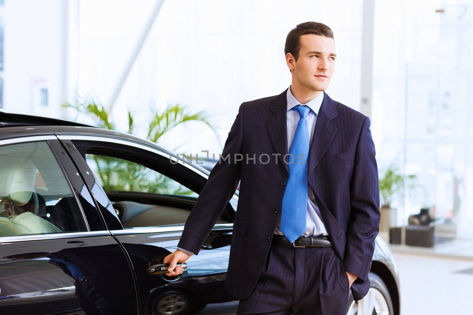 Businessman near car by sergey_nivens