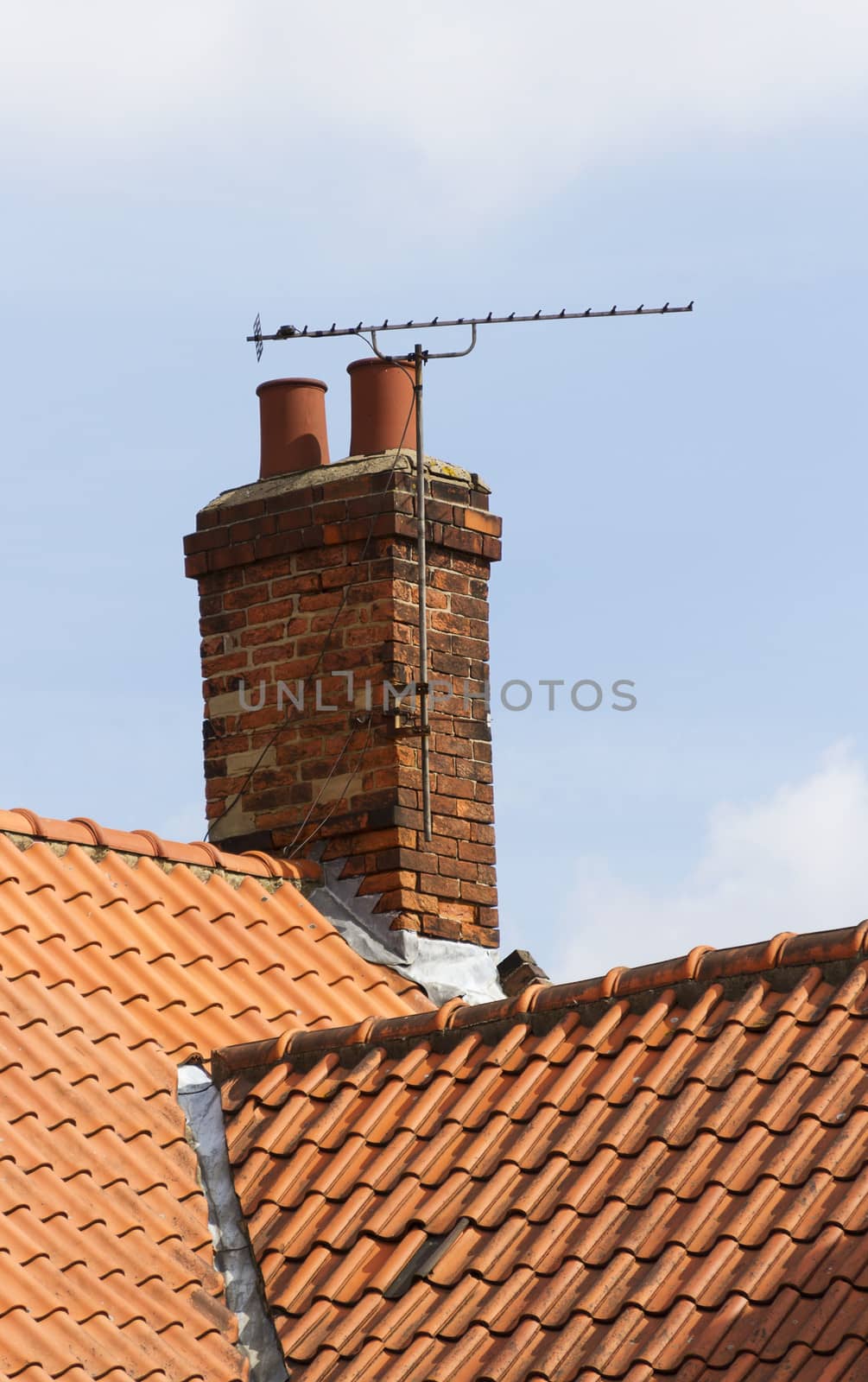 television aerial attached to an old chimney