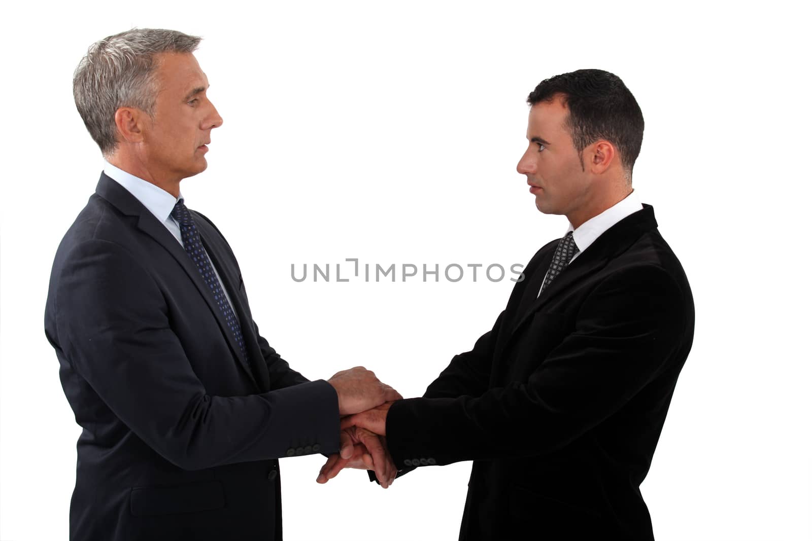 Businessmen shaking hands by phovoir
