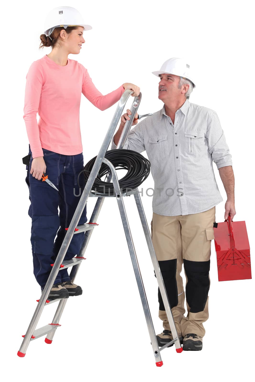 Electrician working with new female recruit by phovoir