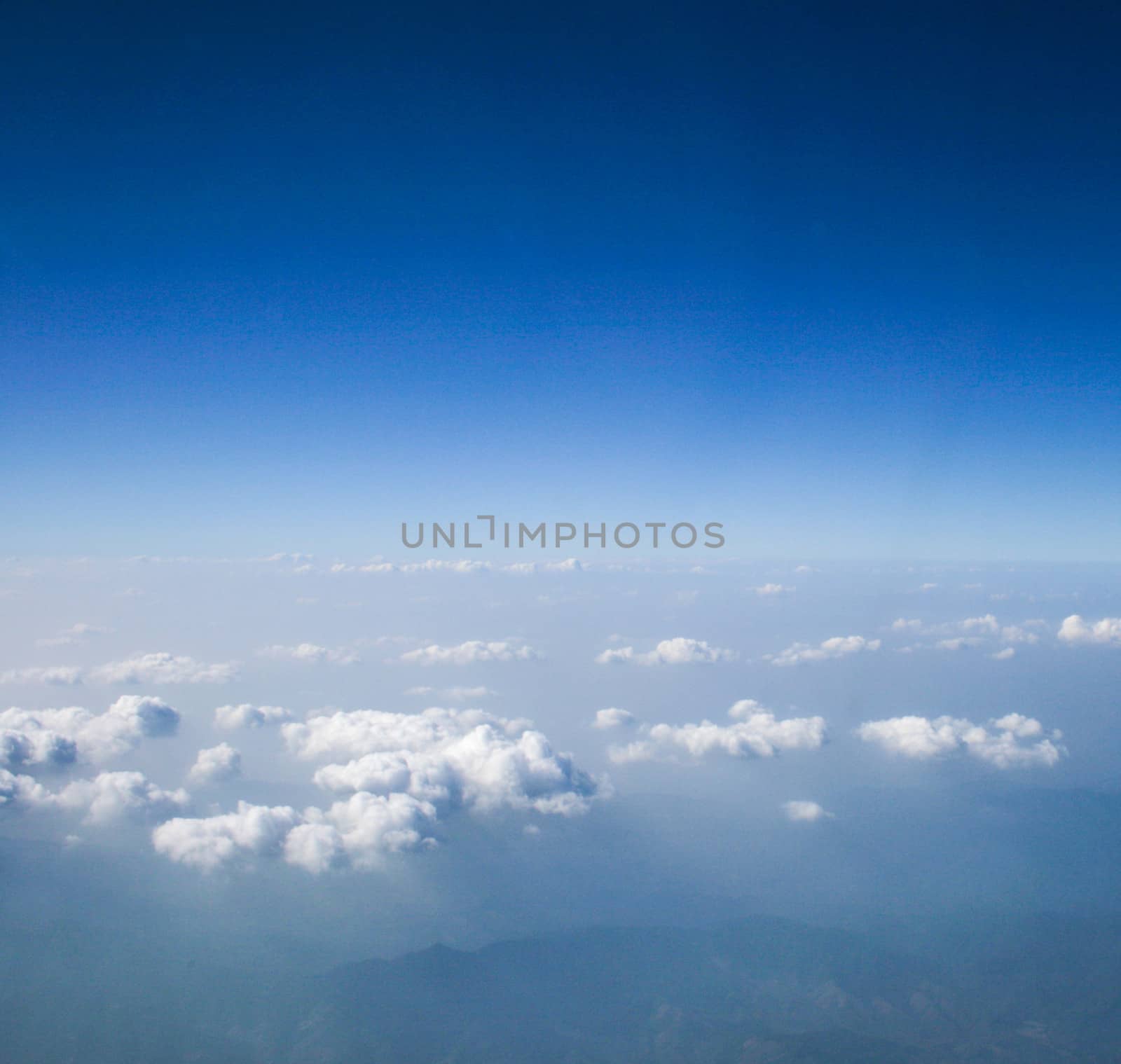 Soft clouds over view from airplane flying