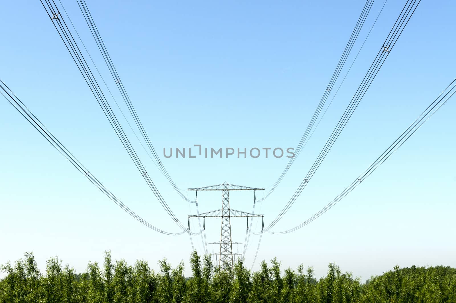 Electricity pylon with pwer lines and blue sky