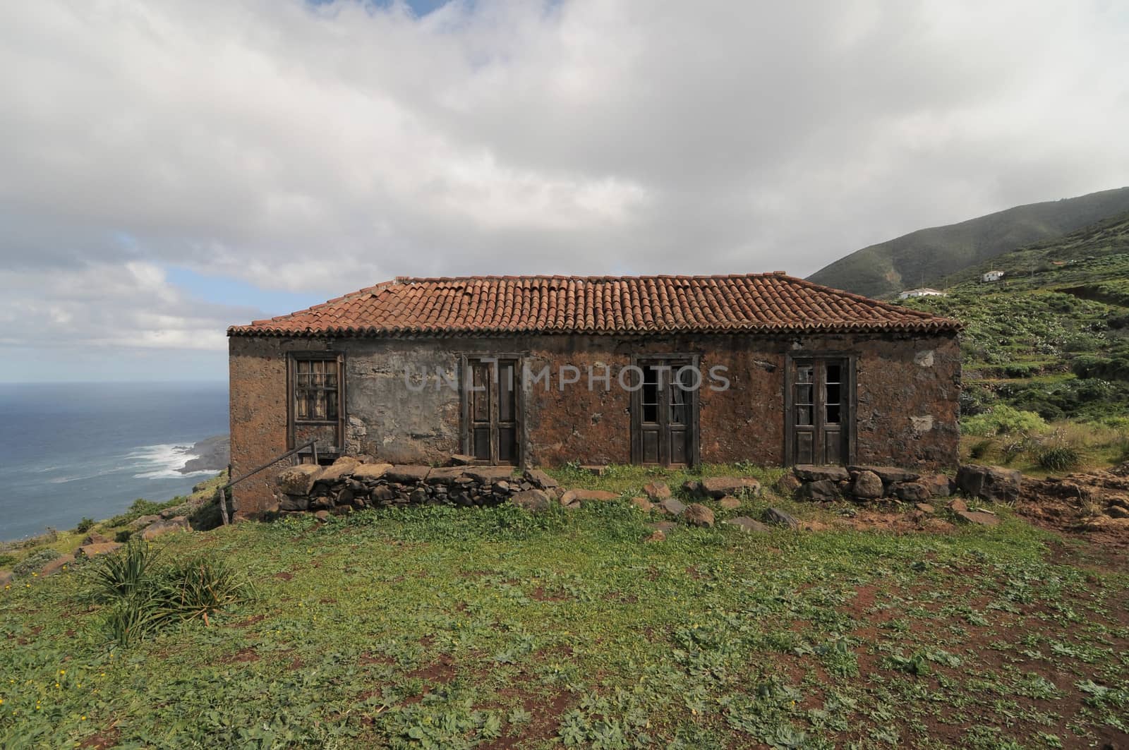 Brown Ancient Rural House on a Cloudy Sky