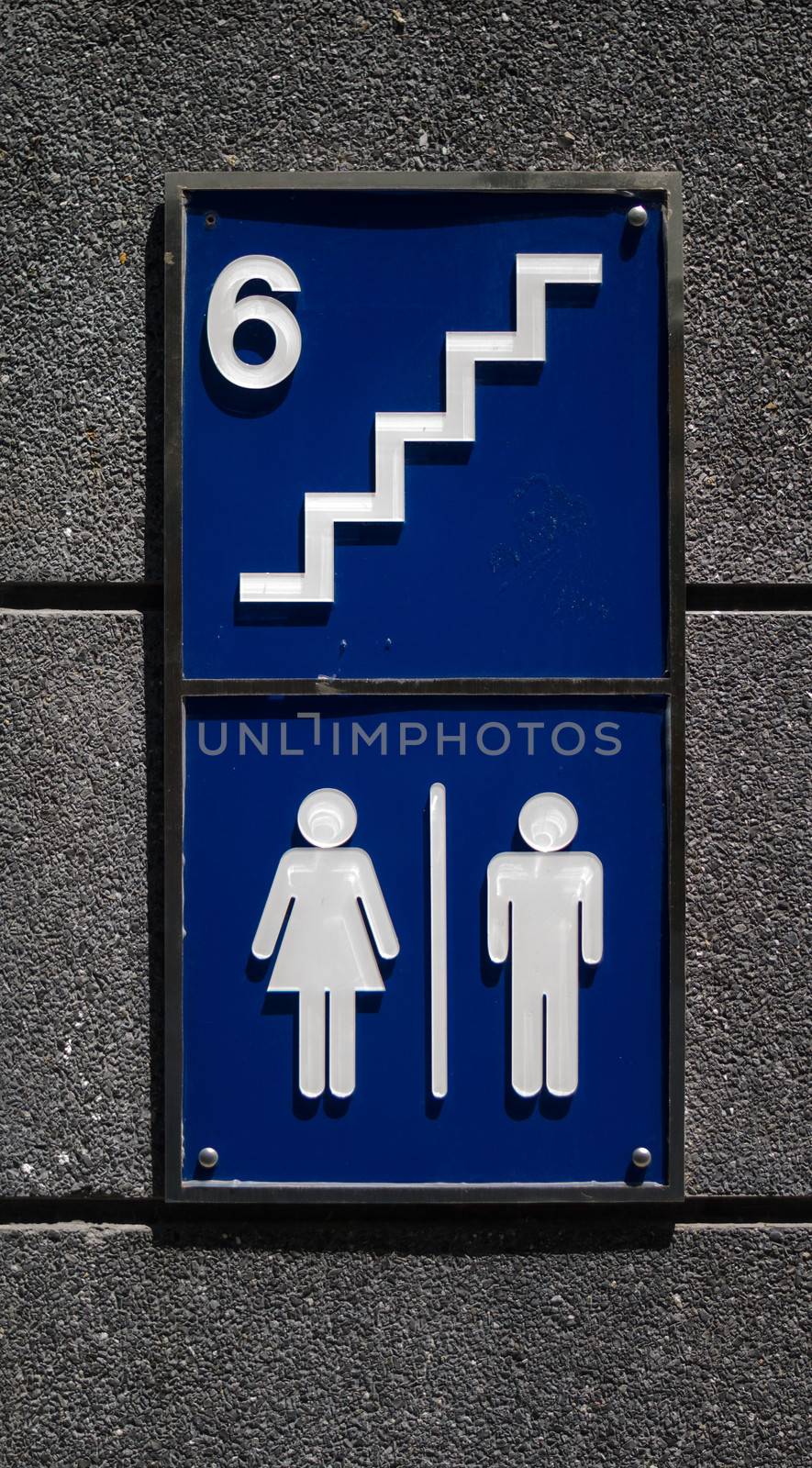 toilet sign on wall at public street by ammza12