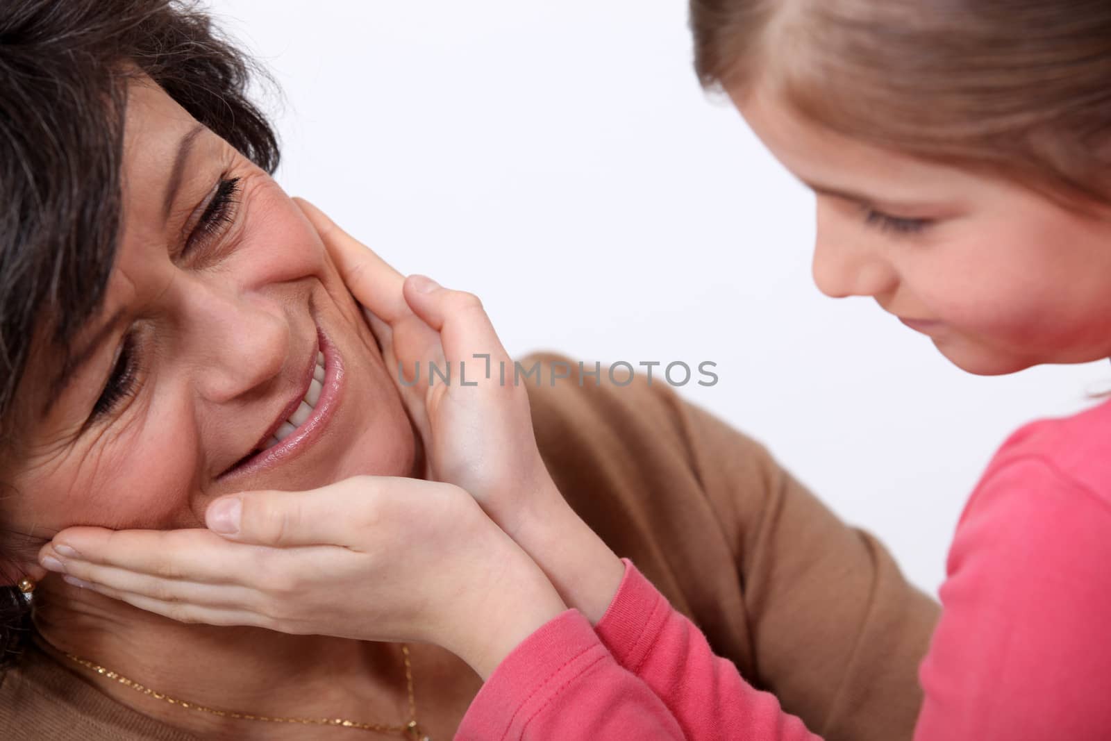 Daughter touching mother's face by phovoir