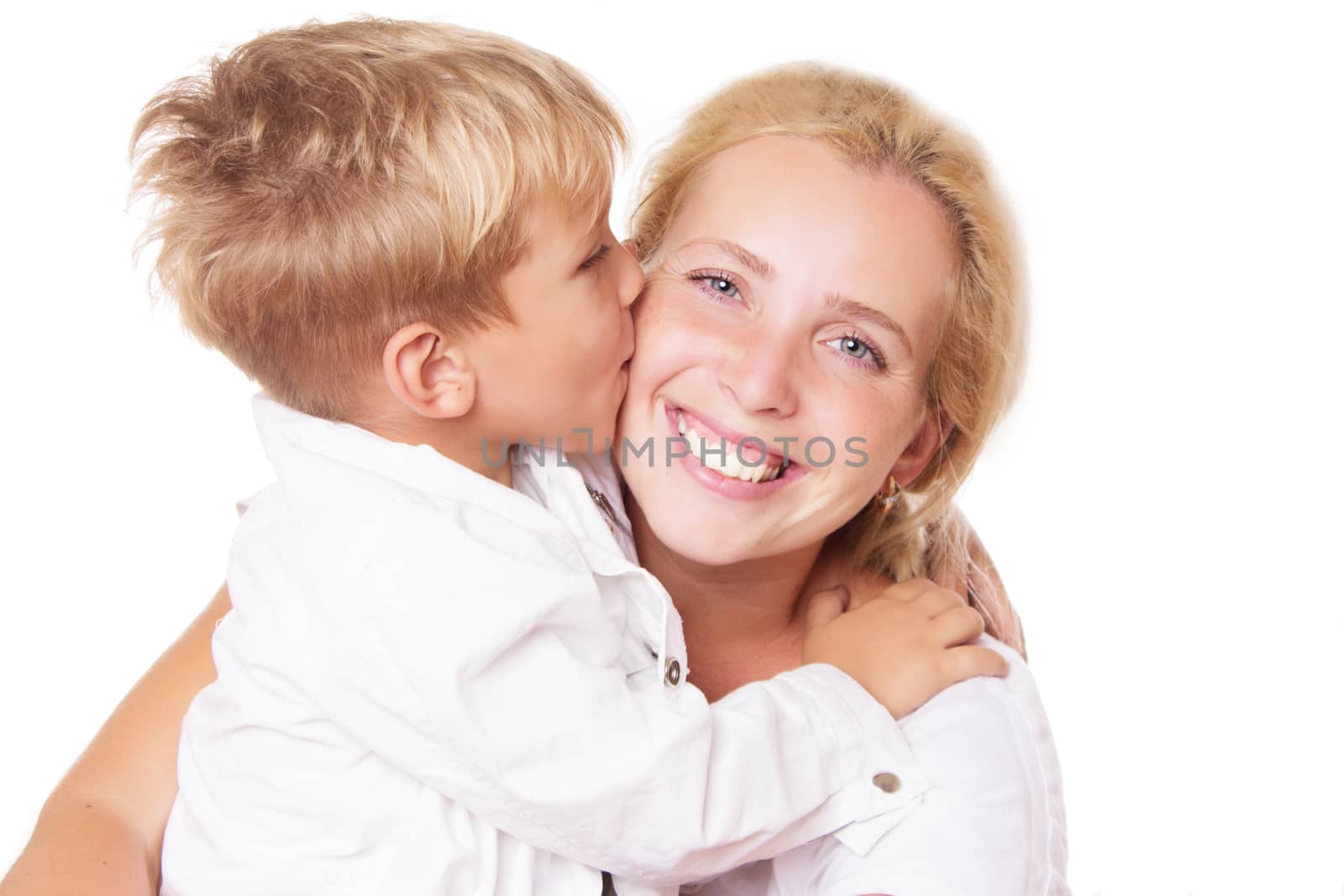 Happy mother and son kissing on cheek over white