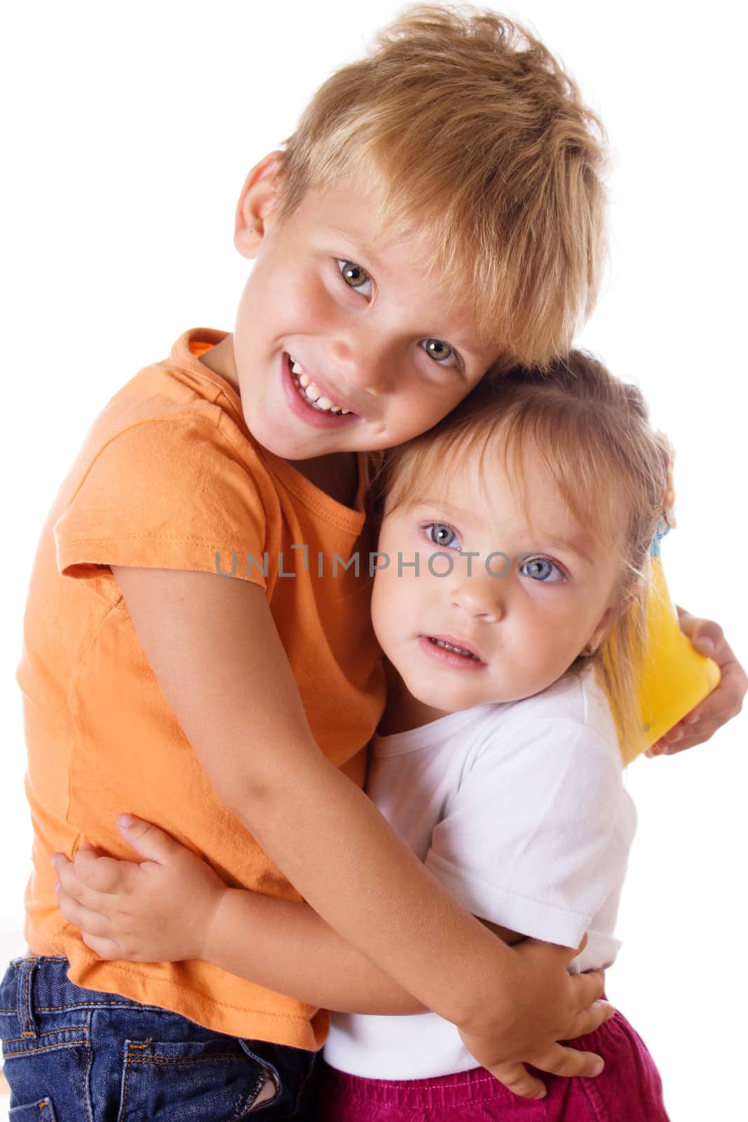 Smiling brother and little sister hugging isolated on white