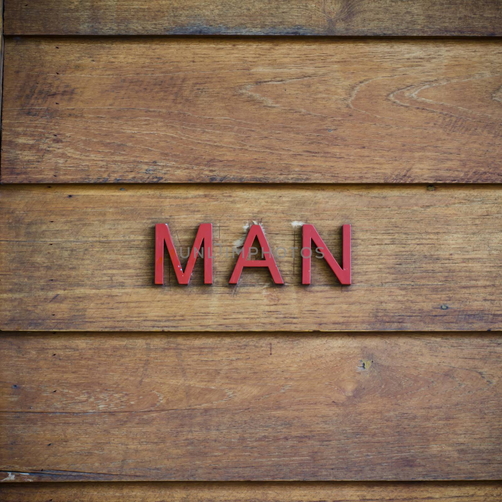 man toilet symbolic on wood background texture