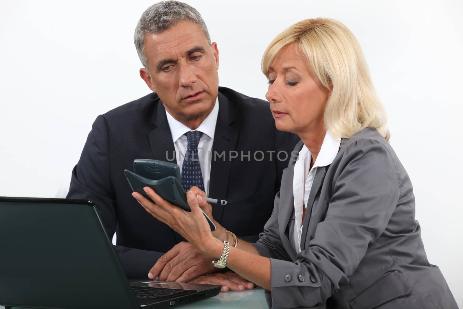 businessman and businesswoman calculating the budget