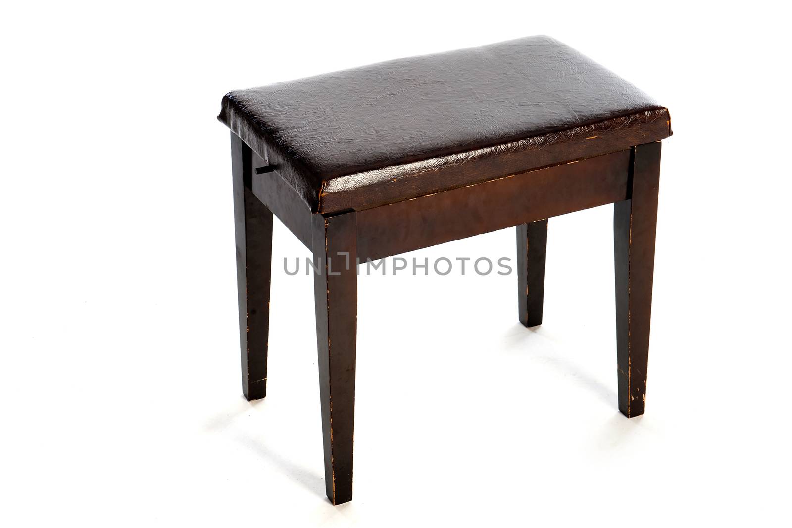 an old piano stool on a white background