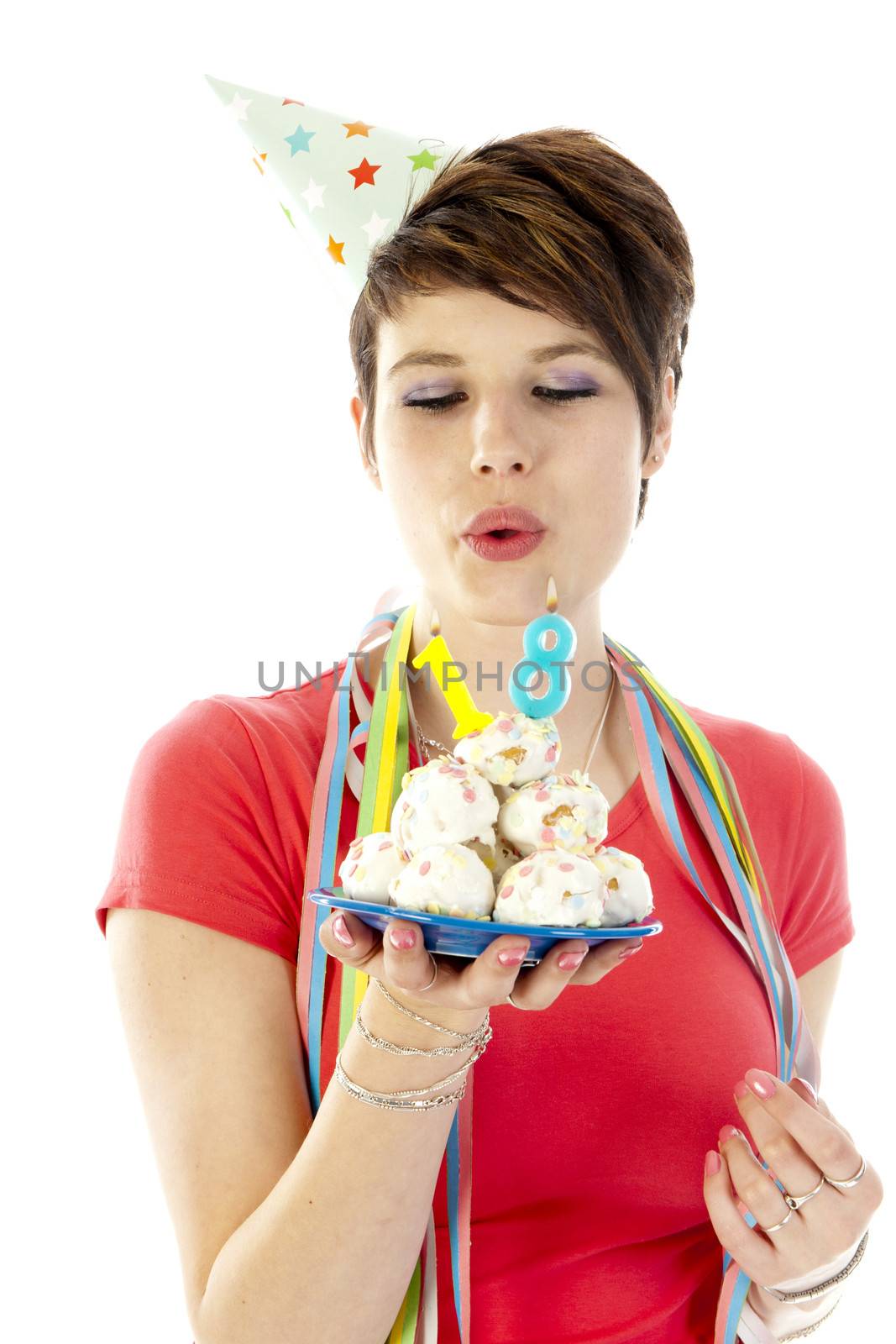 a birthday girl on her 18th birthday, holding a cake with a candle on a white background
