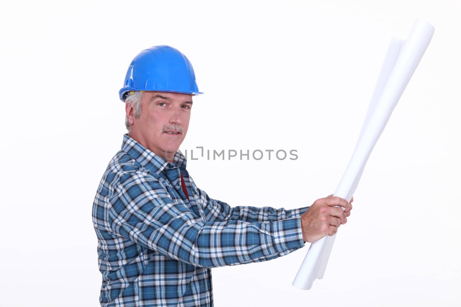 Grey haired foreman looking at plans