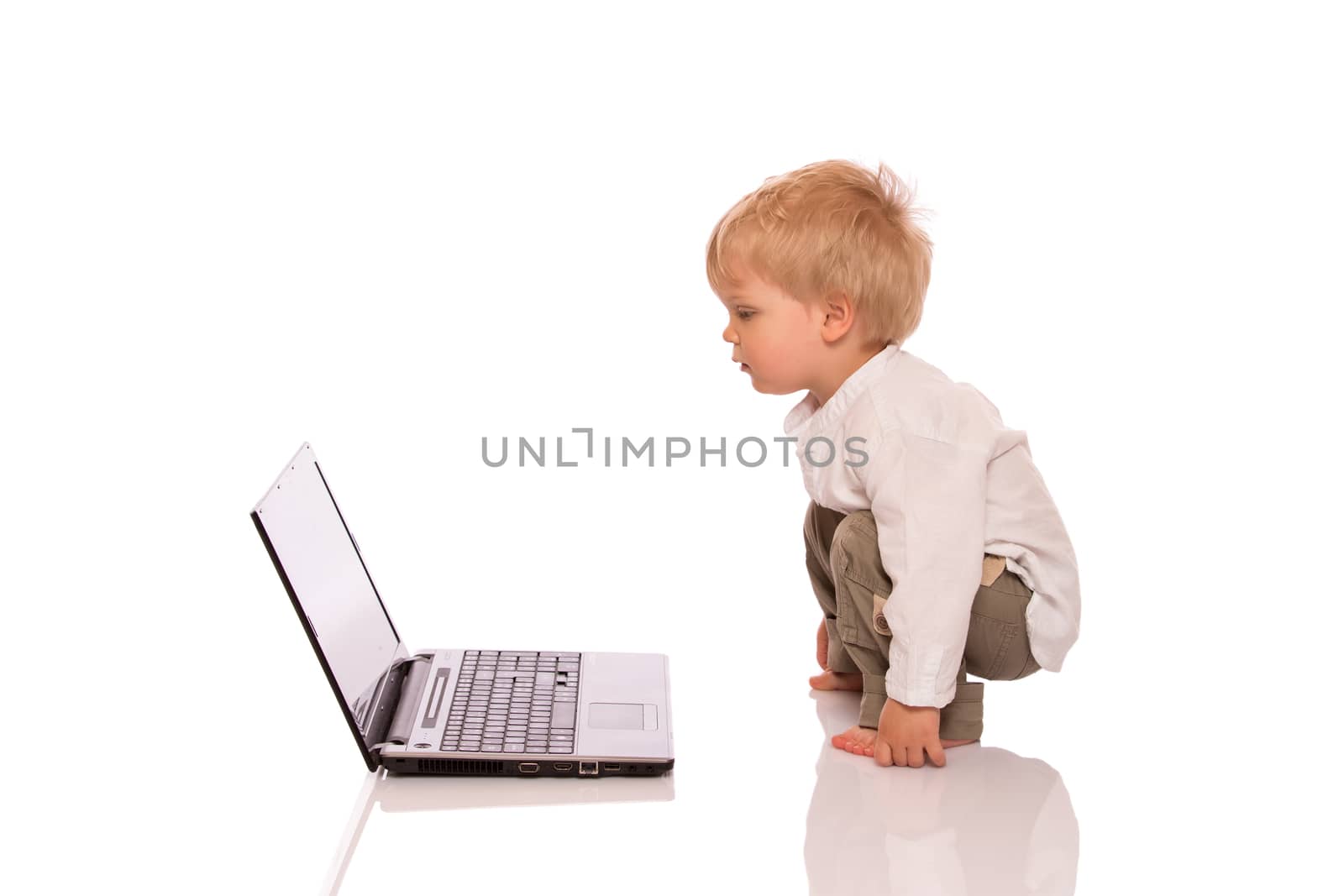 Young boy looking at a laptop by lusjen_n