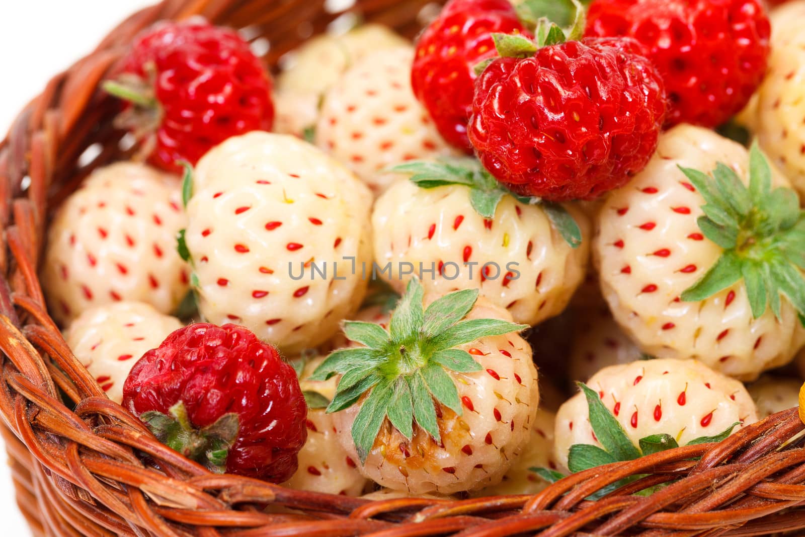 Ripe White and Red Strawberries in basket by Discovod