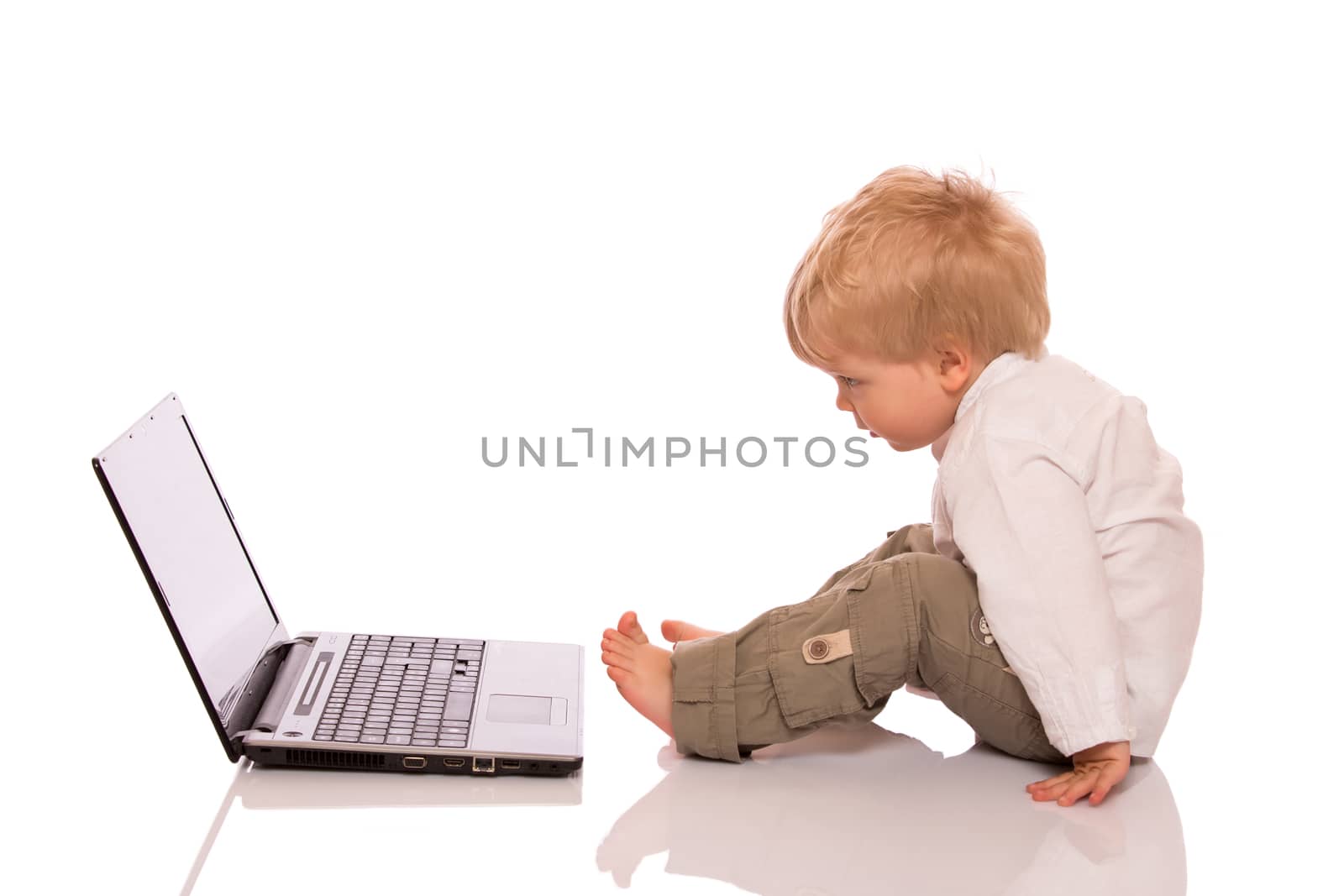 Young boy looking at a laptop by lusjen_n