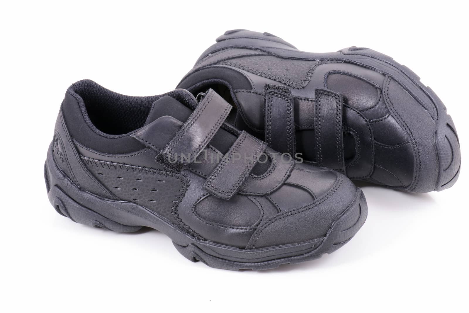 Children black shoes ready back for school, isolated on white background