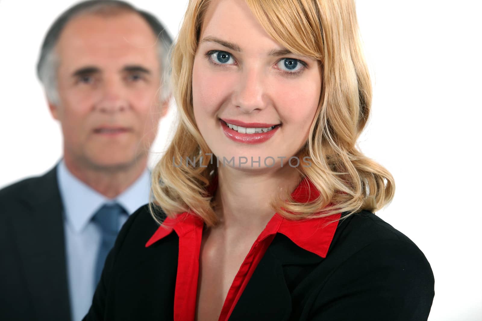 Businessman stood with assistant by phovoir