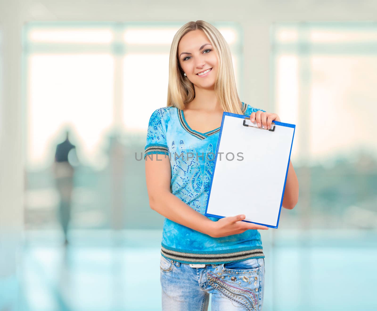 a smiling female holding empty clopboard