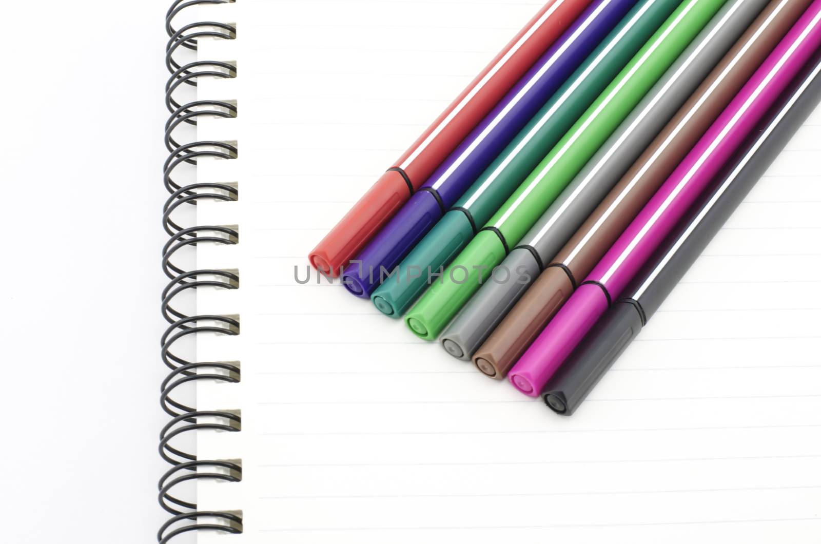 colorful pen with notebook isolated on white background