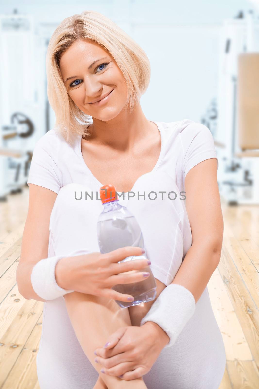 a young sports girl sitting on floor by mihalec