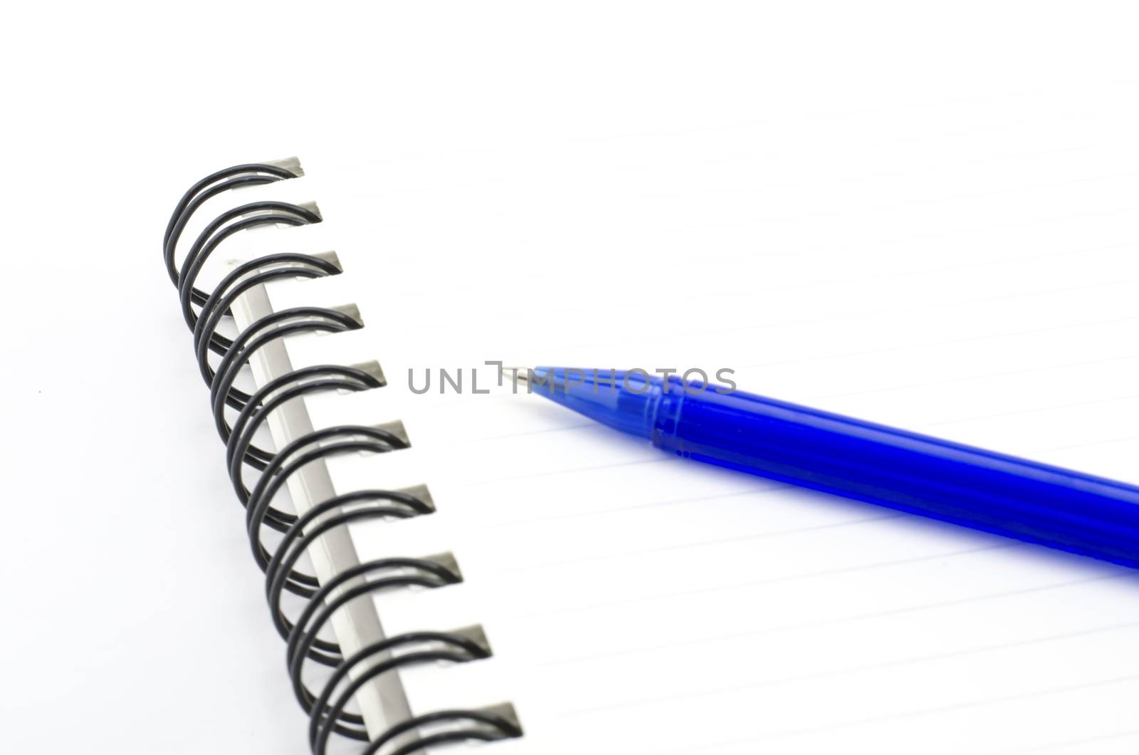 blue pen with notebook isolated on white by ammza12