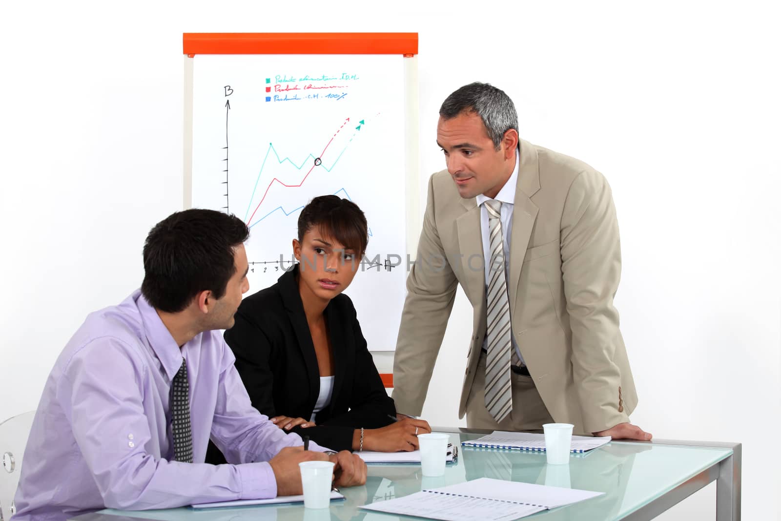 businesswoman and male colleagues at meeting by phovoir