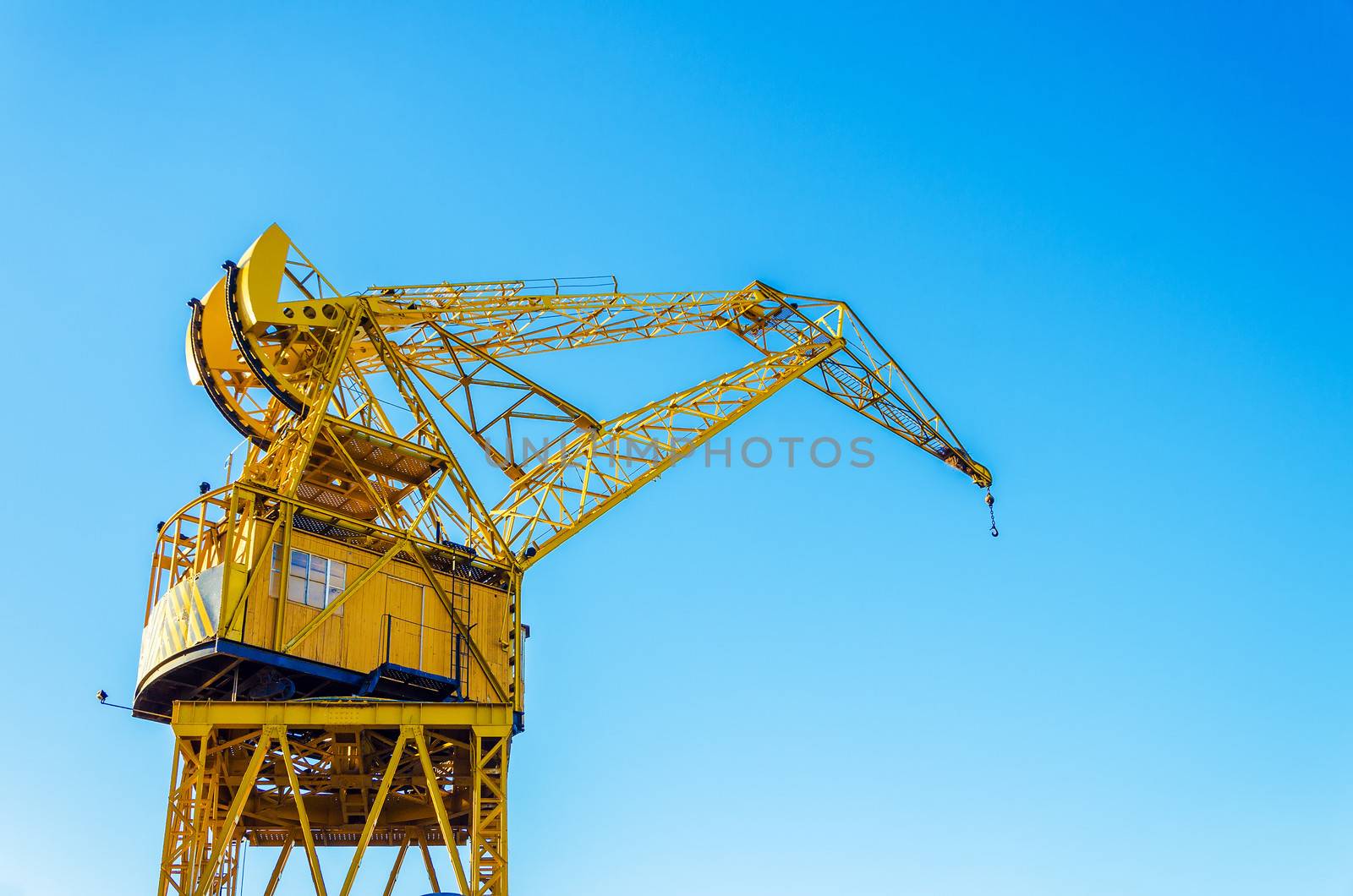 Old yellow crane in Buenos Aires with a beautiful blue sky