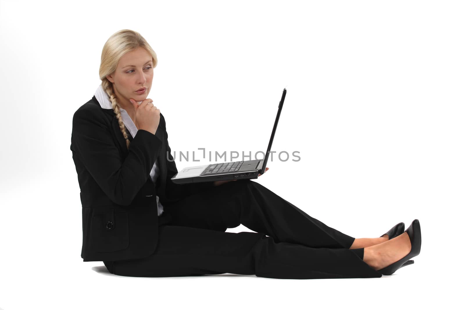 Businesswoman sitting on the floor with her laptop