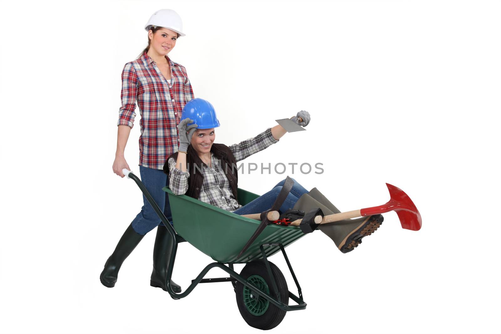 Two women messing around wuth wheelbarrow by phovoir