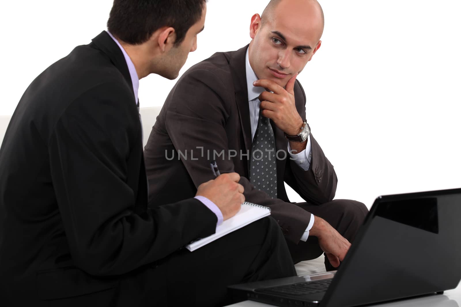 Two businessmen discussing project by phovoir