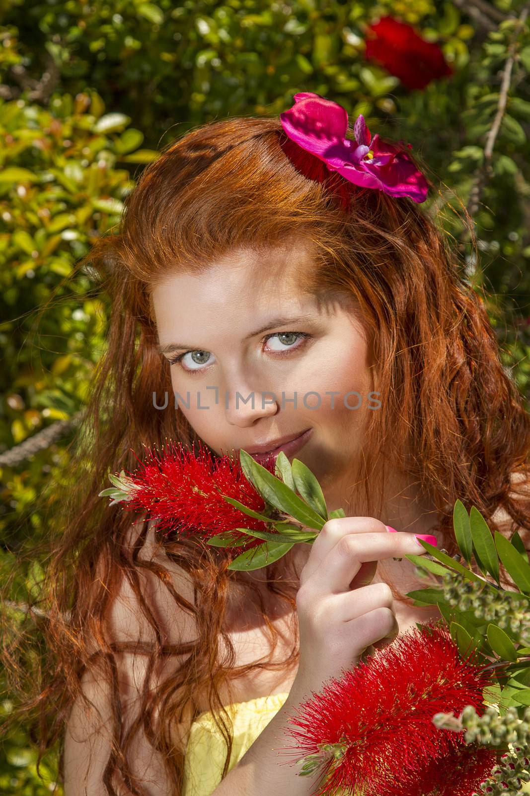 View of a beautiful and happy young woman posing in a garden