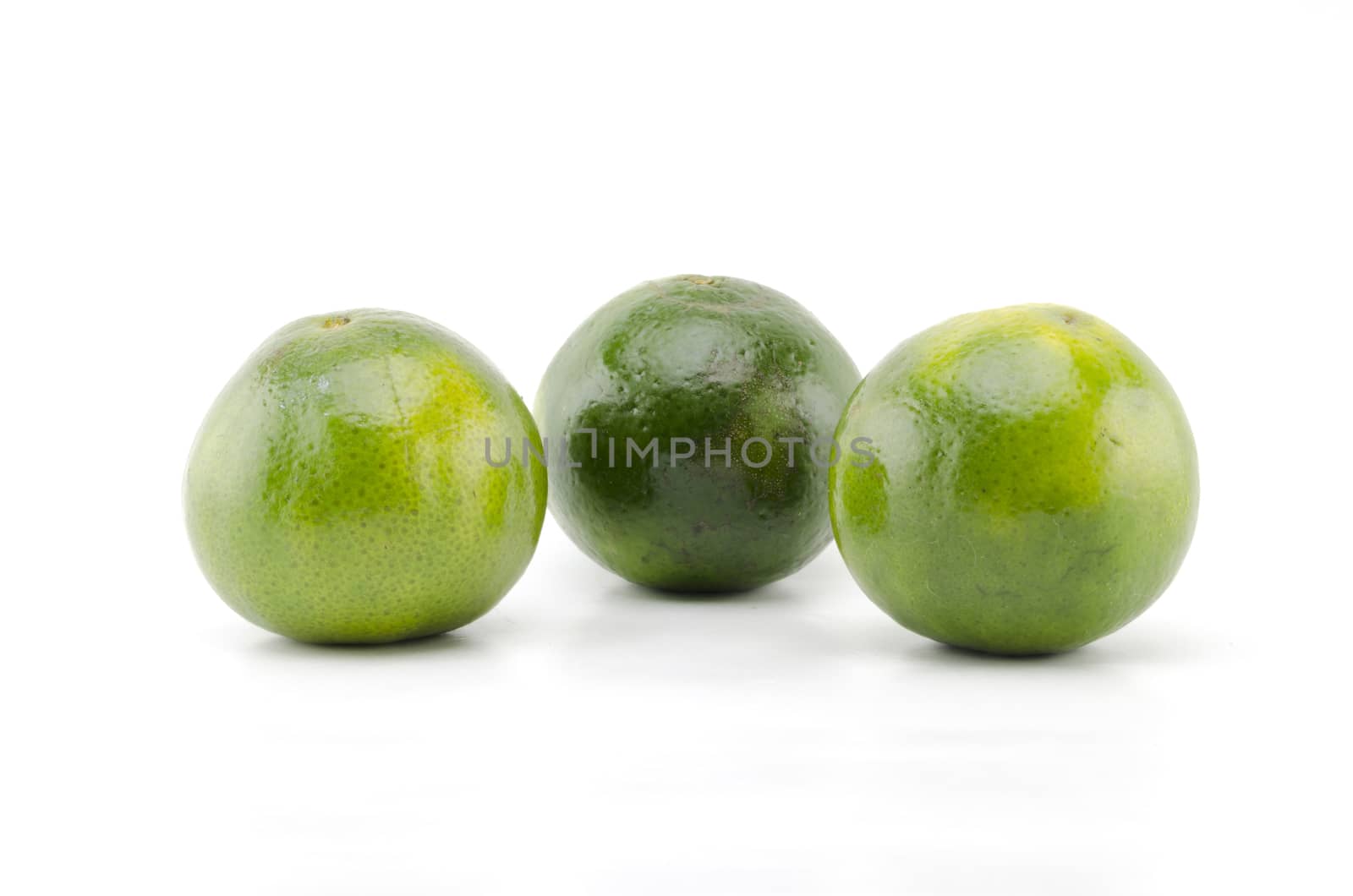 three green orange fruit isolated on white background