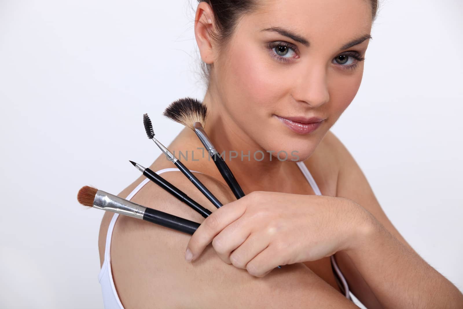 beautiful woman holding make up brushes