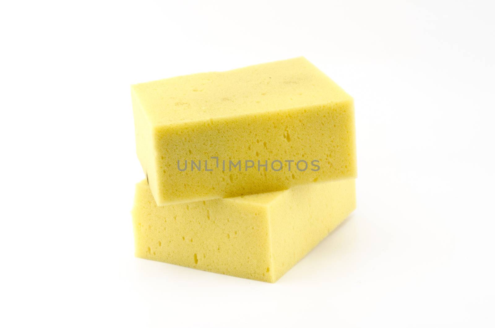 two piece yellow household sponge isolated on white background