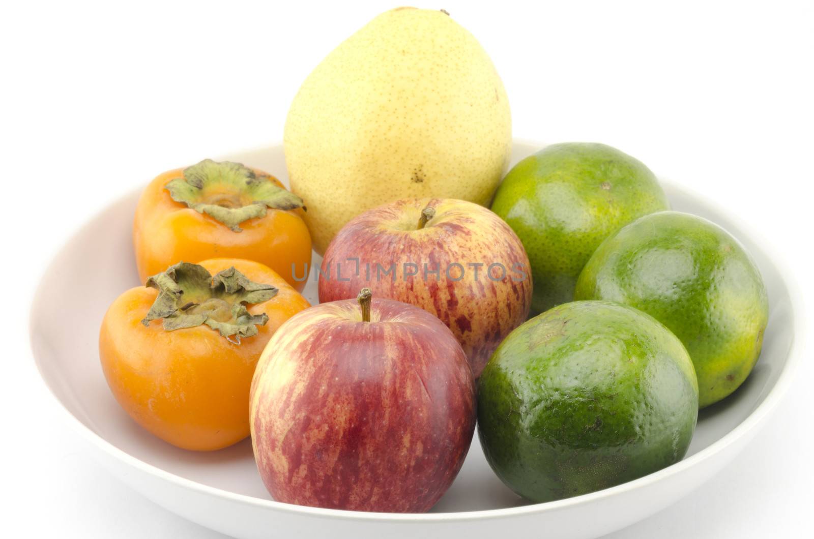 chinese pear apple green orange and persimon on white dish isolated on white background