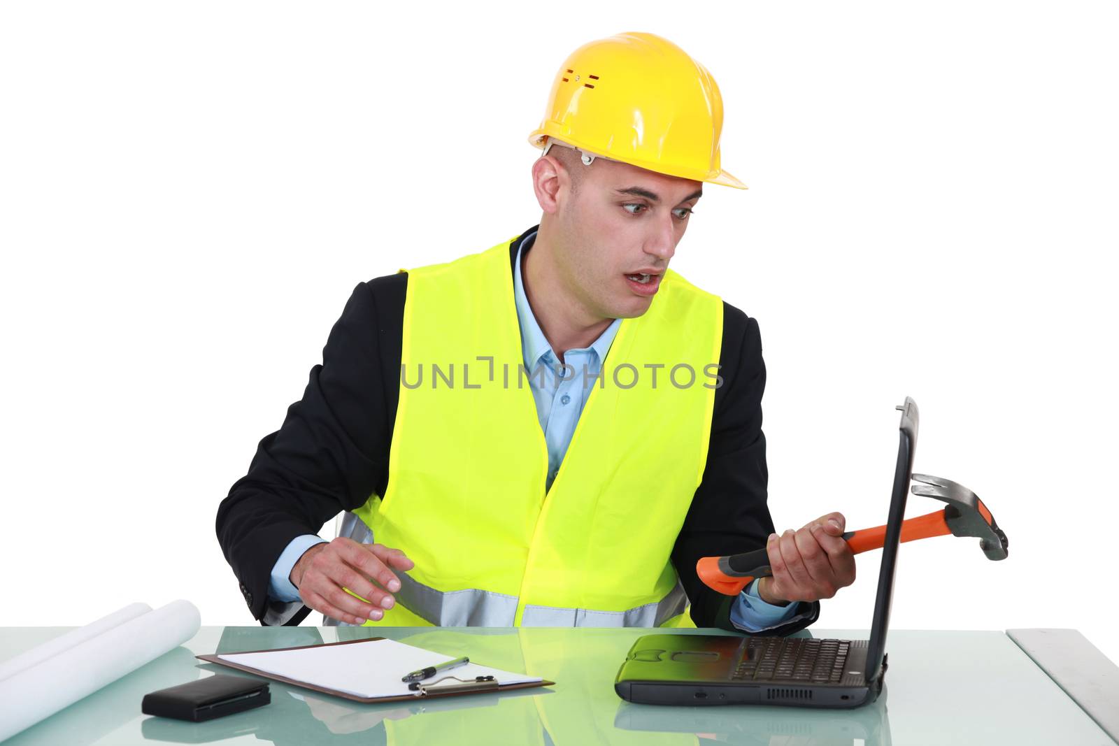 Clumsy architect smashing laptop with hammer