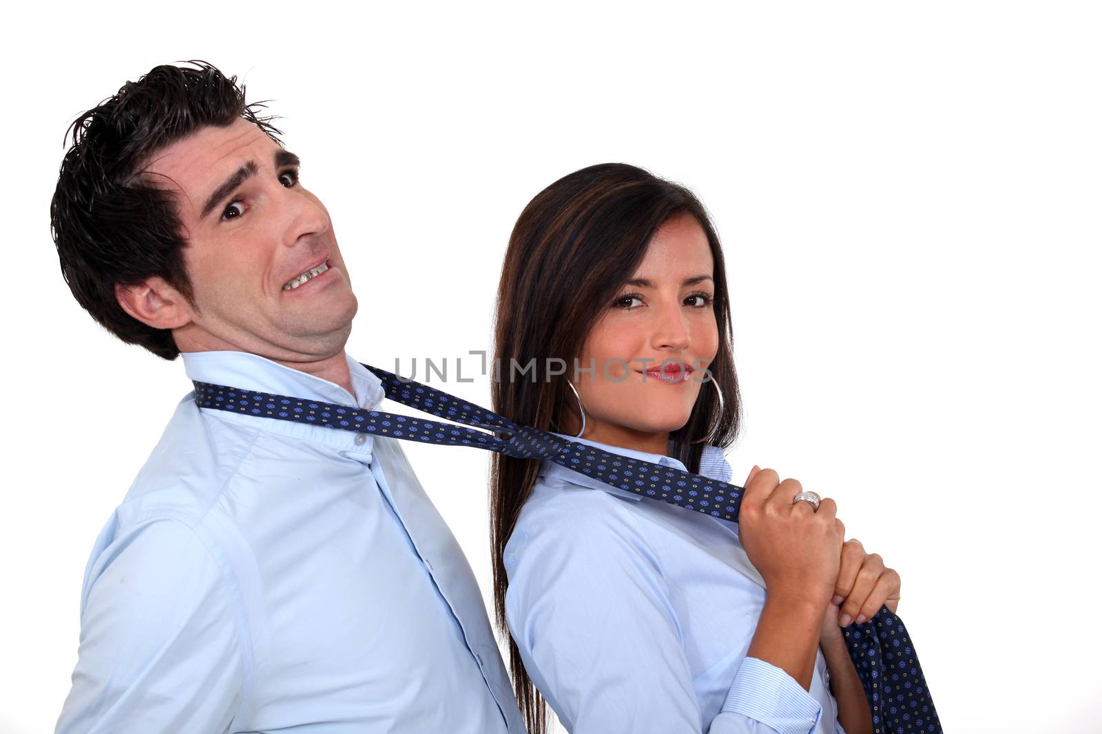 Woman grabbing man by tie by phovoir