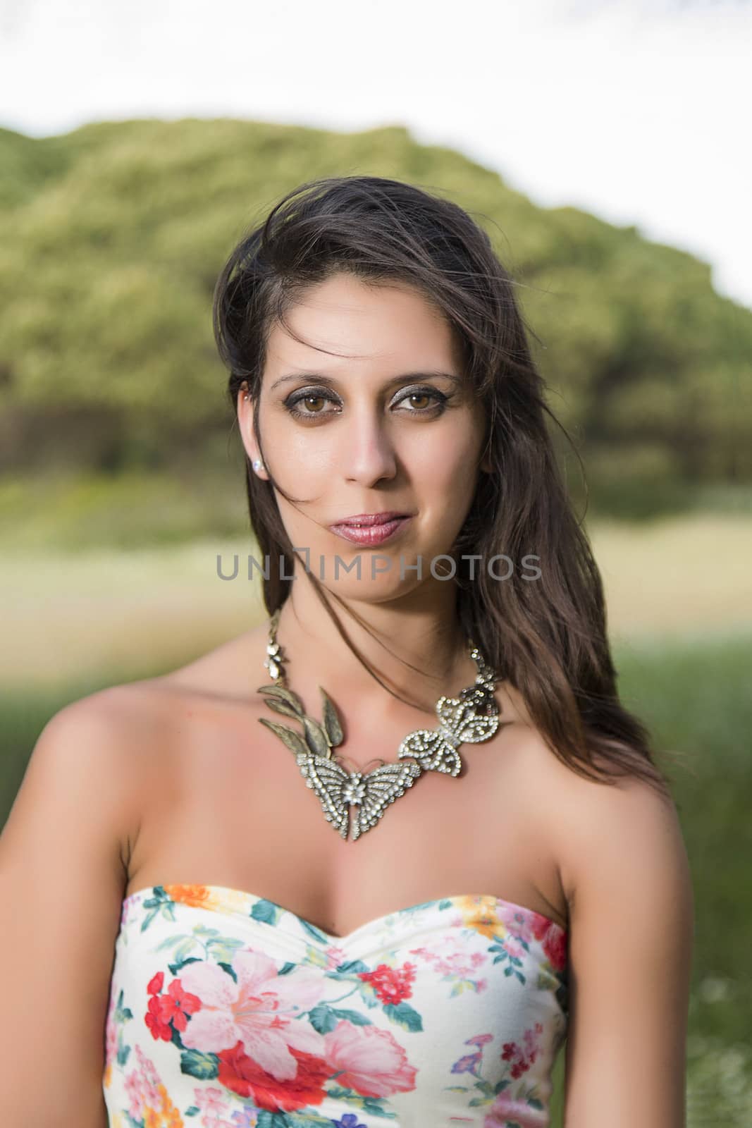  young woman in a floral tight and short dress posing in nature by membio