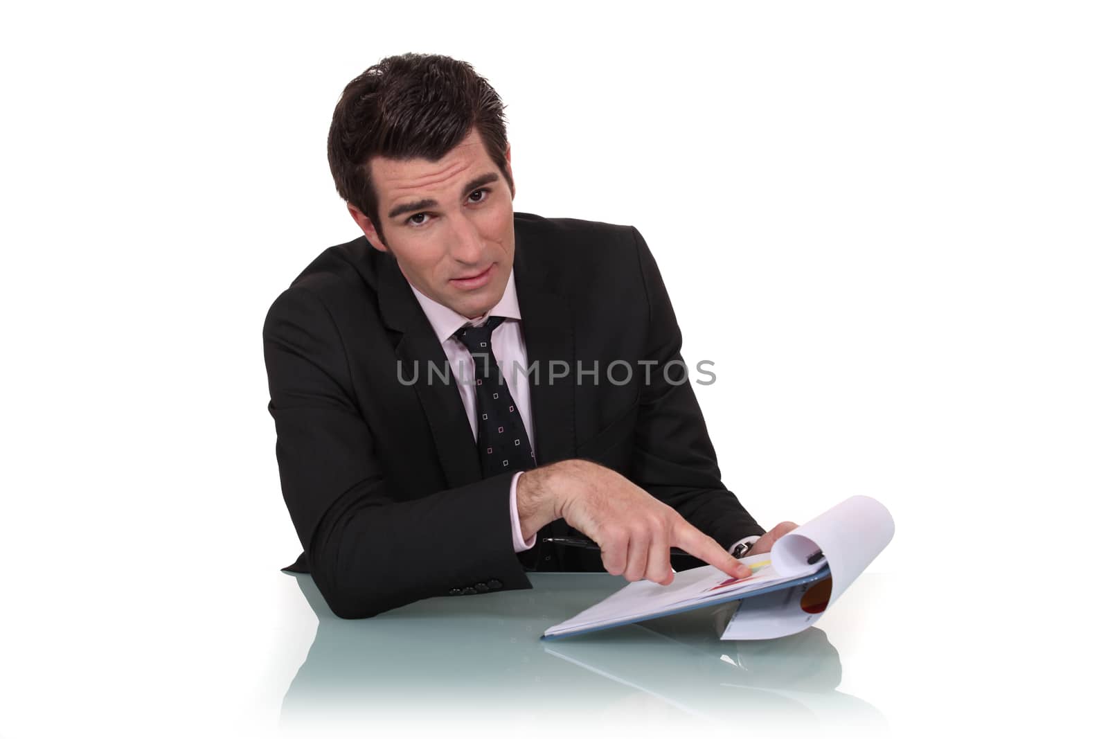 Businessman pointing to his clipboard
