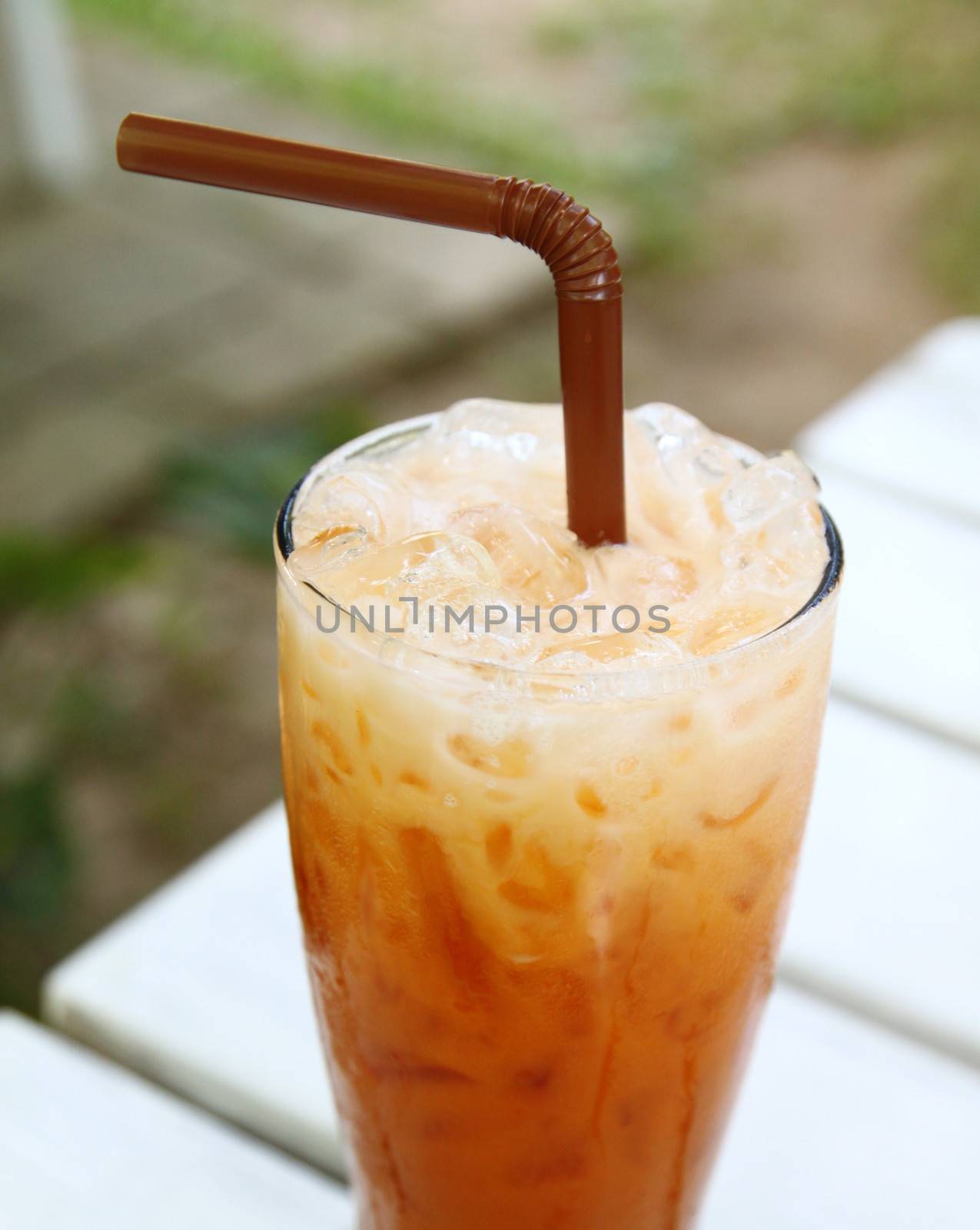 Iced tea with straw by nuchylee