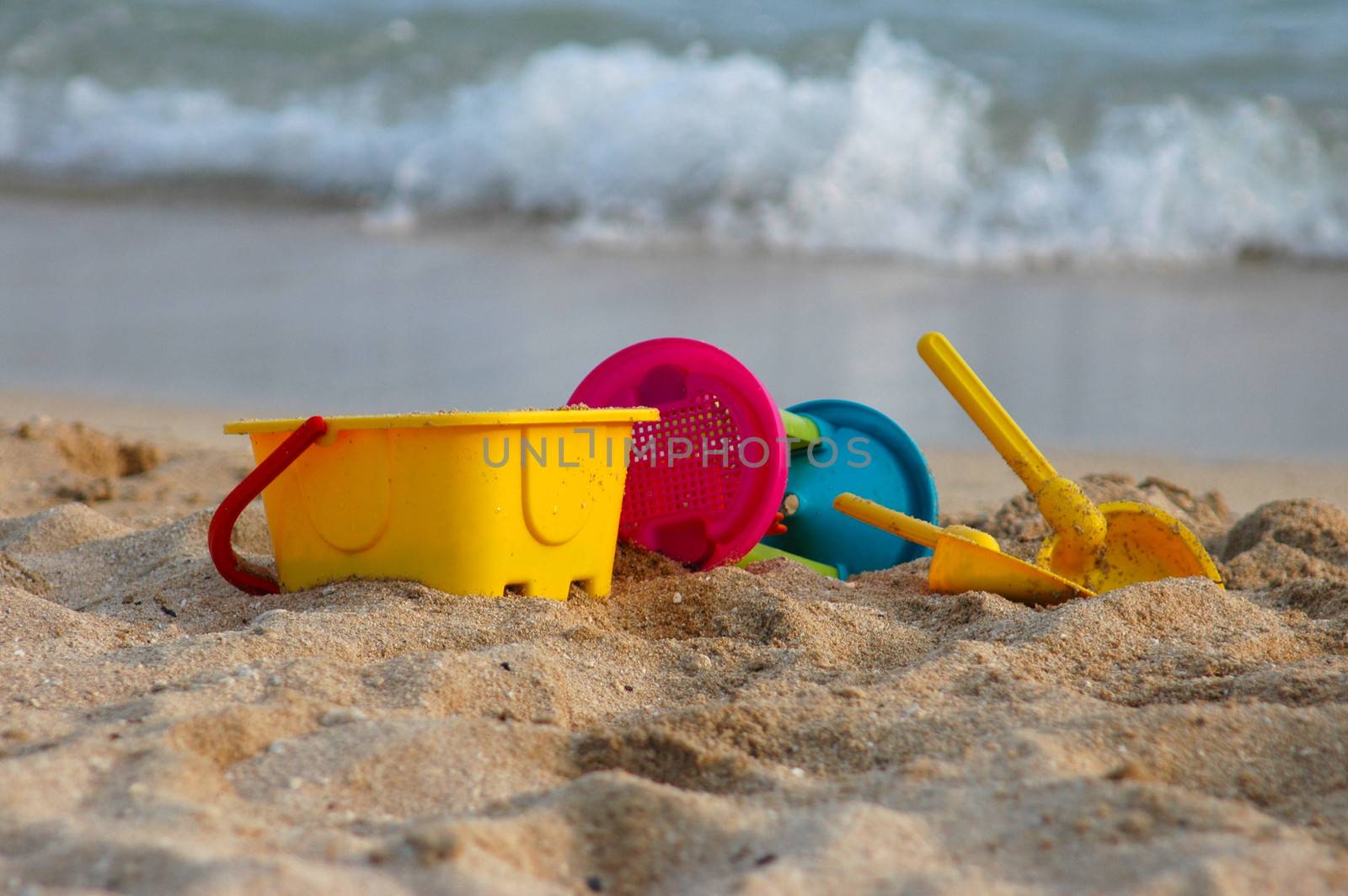 Vacation image of children's beach toys on the sand