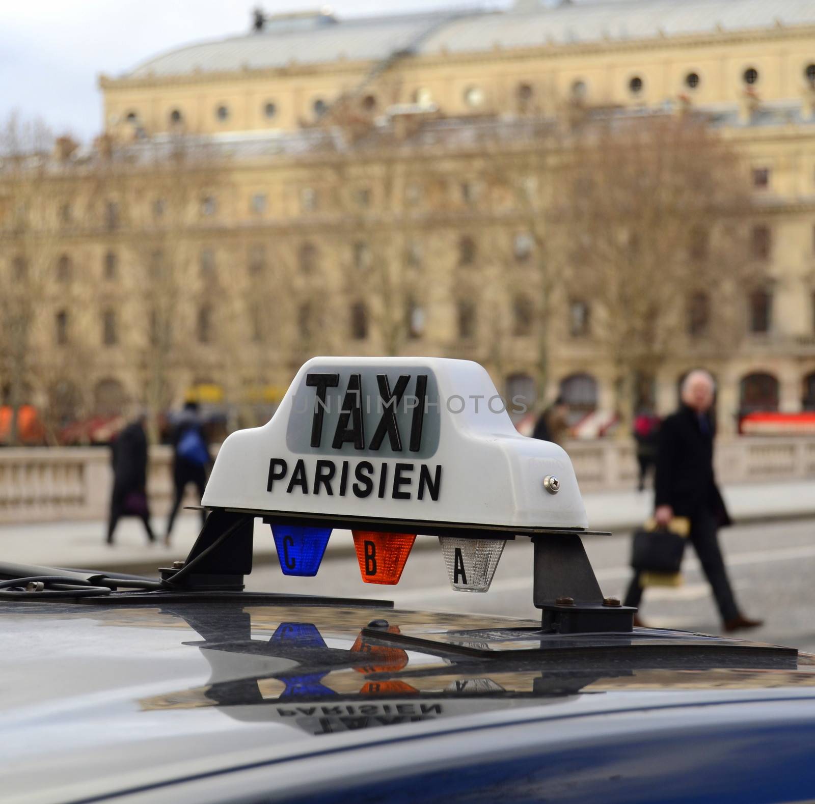 A Paris Taxi On A Bridge Over The River Seine With People In The Background