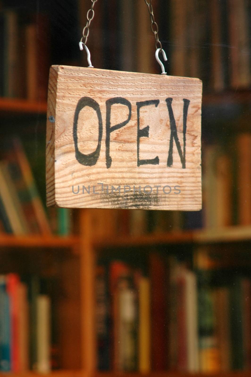 Retail and shopping image of an open sign in a book shop window