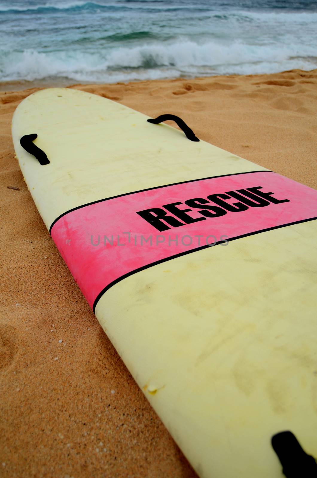 A Lifeguard's Rescue Surfboard On A Hawaiian Beach On A Stormy Day