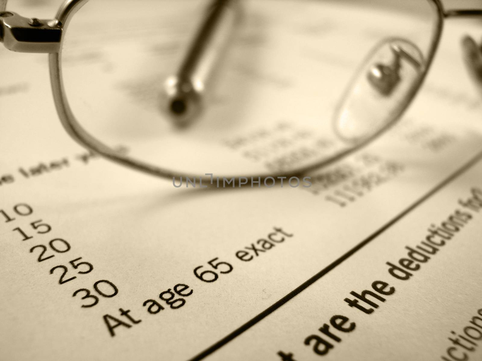 Retirement image of pension plan form with glasses and pen